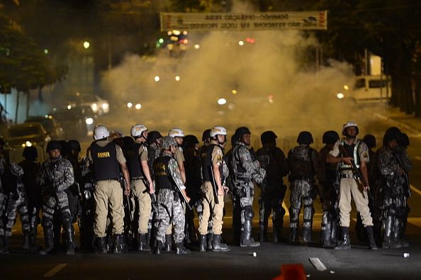 Riot policemen take their positions during a protest against corruption and price hikes in Belo Horizonte, Brazil on June 22, 2013. Brazil girded for more street protests Saturday despite President Dilma Rousseff's conciliatory remarks pledging to improve public services and fight corruption, while warning against further violence. Her speech came a day after more than one million people marched in cities across the country to slam the huge cost of hosting next June's World Cup, put at some 15 billion dollars, while public services such as schools and hospitals are lacking. AFP PHOTO / Yuri CORTEZ (Photo credit should read YURI CORTEZ/AFP/Getty Images)